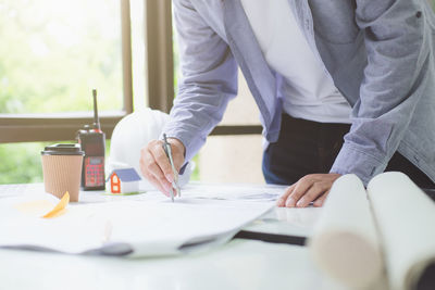 Midsection of man working on table