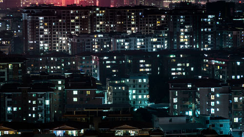 High angle view of illuminated buildings at night