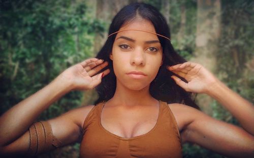 Close-up portrait of young woman standing outdoors
