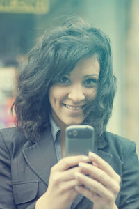 Portrait of young woman using smart phone