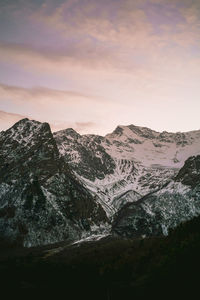 Scenic view of snowcapped mountains against sky during sunset