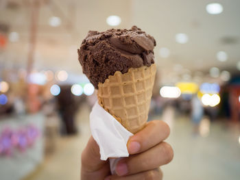 Close-up of hand holding ice cream cone