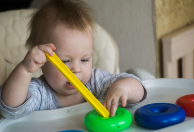 Portrait of cute boy holding baby at home