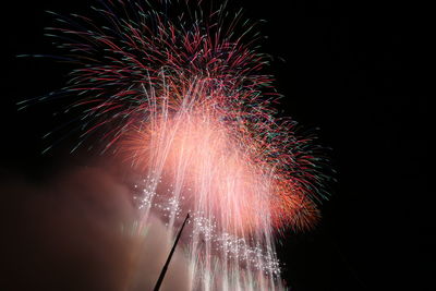 Low angle view of firework display at night