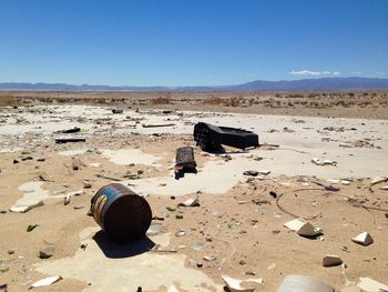 Abandoned can at desert against clear blue sky