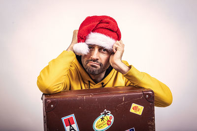 Portrait of man wearing hat against white background