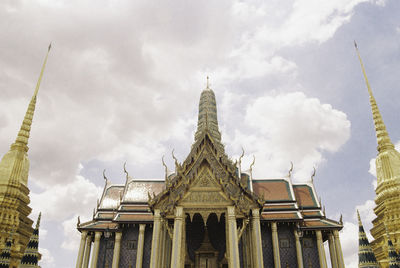 Low angle view of temple building against cloudy sky