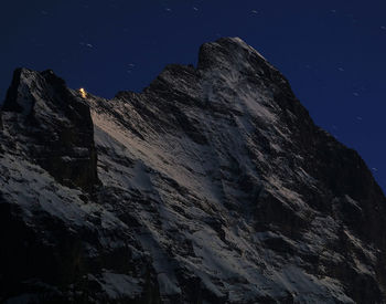 Low angle view of mountains against clear sky at night