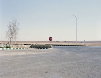 Street light on road against clear sky