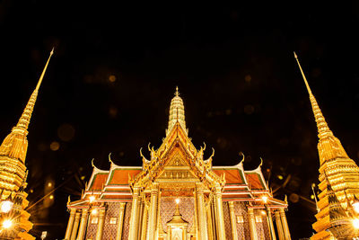 Low angle view of illuminated temple building at night