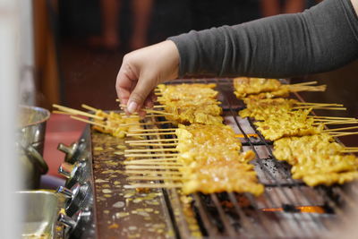 Cropped hand of person preparing food