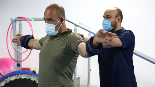 A physical therapist treats a patient in a physical therapy clinic. natural treatment,