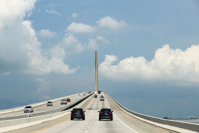 Cars on road against sky