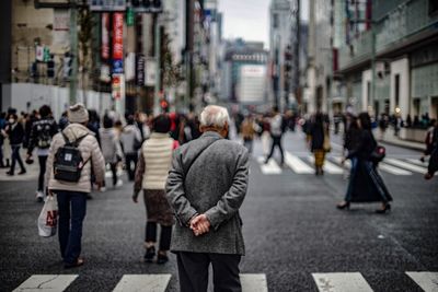 People crossing road in city