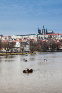 Scenic view of river and buildings against sky