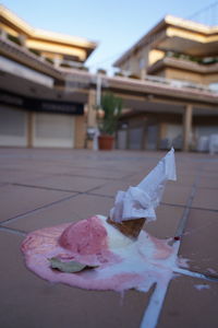 Close-up of ice cream on table against building