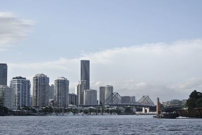 View of river and buildings against sky