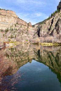 Scenic view of lake by mountains against sky