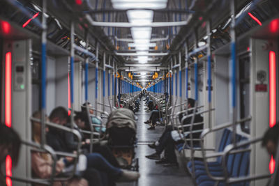 Rear view of people walking in train