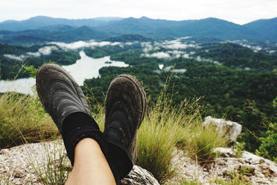 Low section of person relaxing on mountain