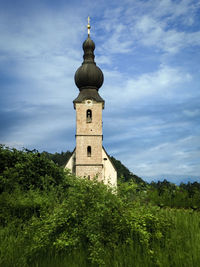 Low angle view of bell tower against sky