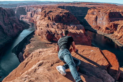 Rear view of man on rock formation