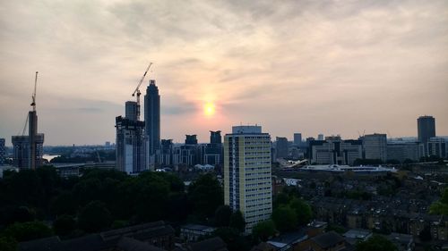 View of cityscape against cloudy sky