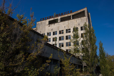 Low angle view of buildings against clear blue sky