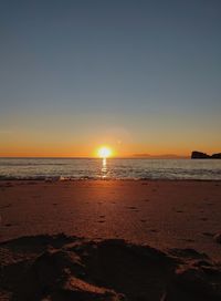 Scenic view of sea against clear sky during sunset