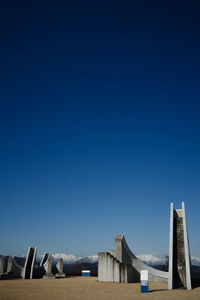 Low angle view of modern buildings against clear blue sky