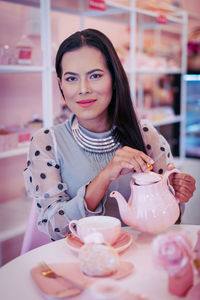 Portrait of smiling woman holding ice cream