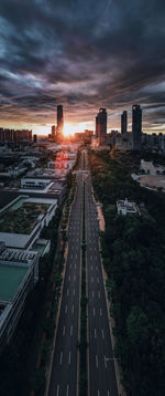 High angle view of street amidst buildings against sky during sunset