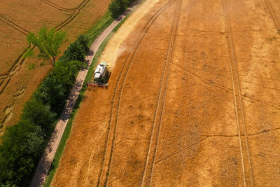 Aerial view of a combine harvester at work during harvest time. agricultural background.