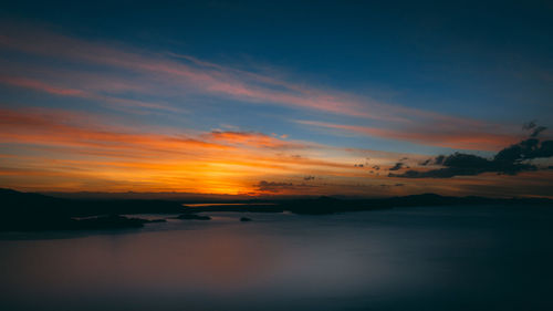 Scenic view of sea against romantic sky at sunset