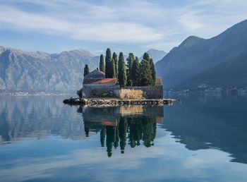 Scenic view of lake and mountains against sky