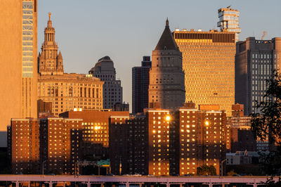 Illuminated buildings in city at dusk