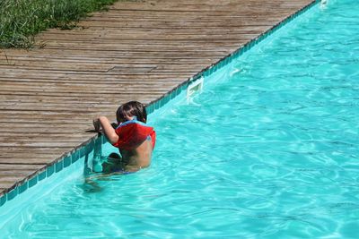 Man relaxing in swimming pool