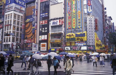 People walking on street in rain