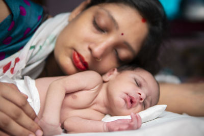 Close-up of cute girl sleeping at home