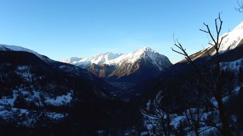 Scenic view of snowcapped mountains against clear sky