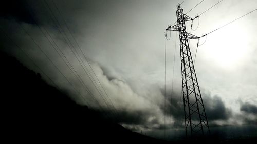 Low angle view of barbed wire against sky