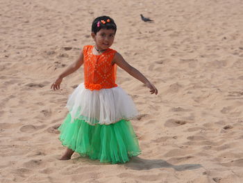 Portrait of young woman standing at beach