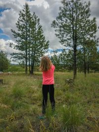 Rear view of girl standing on field