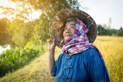 Senior farmer standing on field