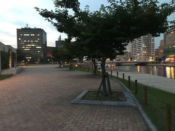 Footpath amidst buildings in city at night