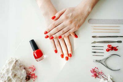 High angle view of woman hand on red table