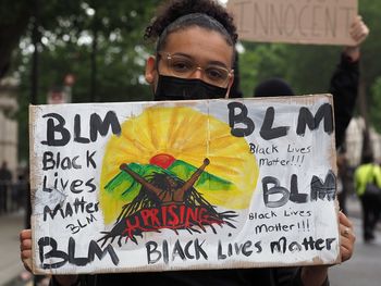 Portrait of man holding sign