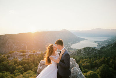 Rear view of woman standing against mountain