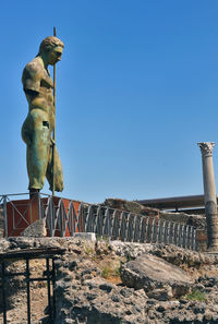 Statue against clear blue sky