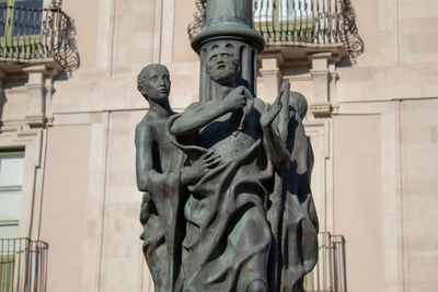 Low angle view of statue against building